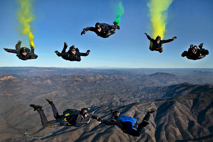 Skydivers in Freefall with Colored Smoke Trails