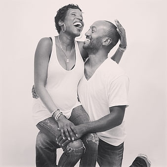 Happy Black Couple Laughing Together in Studio Portrait
