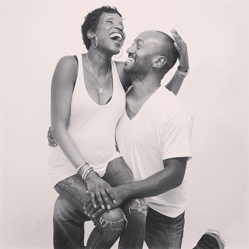 Happy Black Couple Laughing Together in Studio Portrait