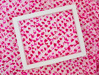 White Frame on Pink Heart Patterned Fabric Background
