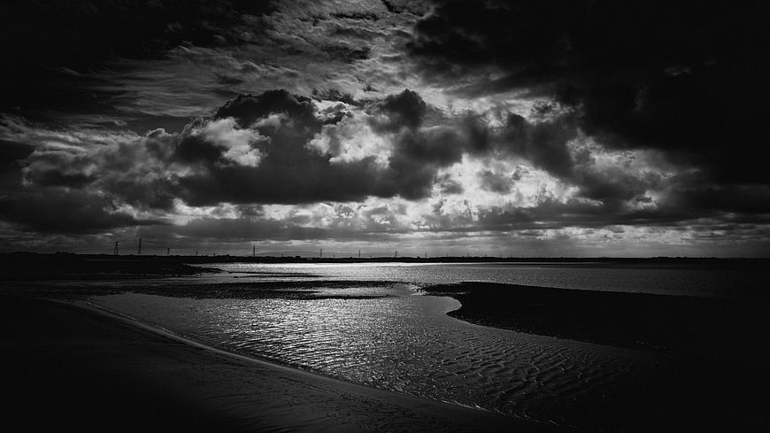 Dramatic Black and White Stormy Sky Over Coastal Landscape