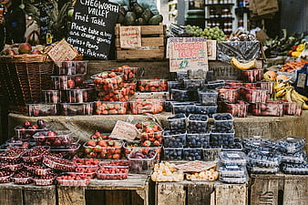 Fresh organic berries and fruit at rustic market stall