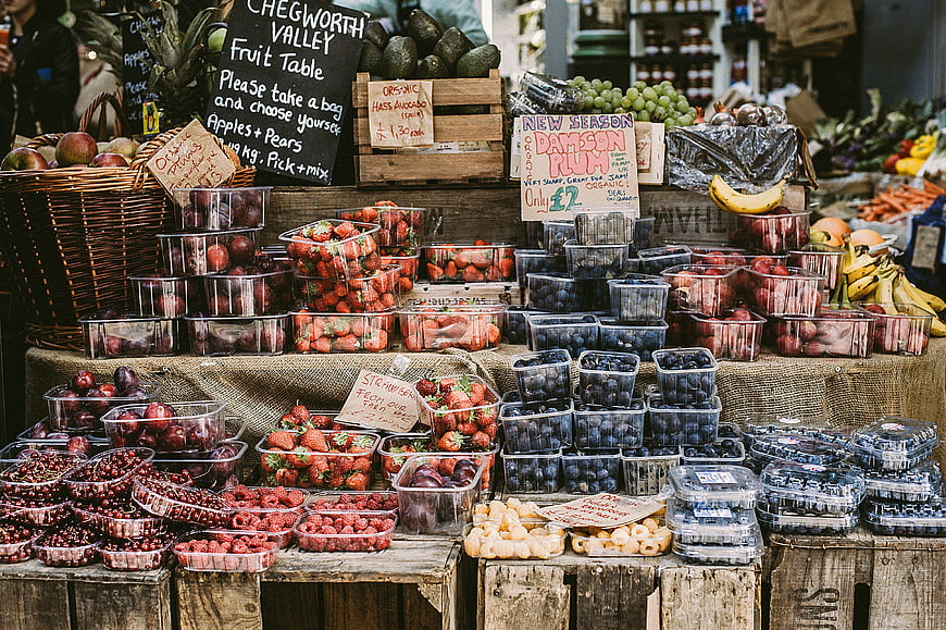 Fresh organic berries and fruit at rustic market stall