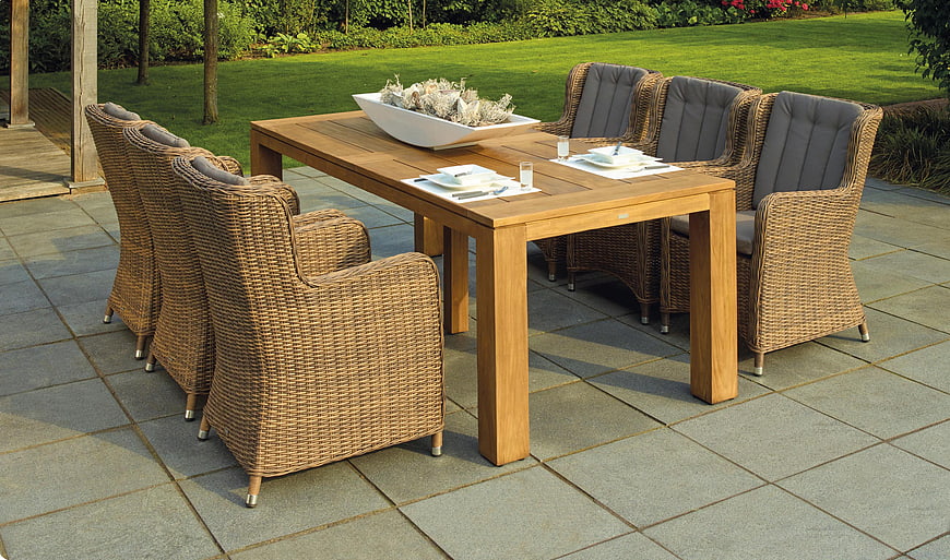 Outdoor Dining Set on Stone Patio with Garden Background