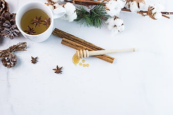 Winter Tea Flat Lay with Honey, Cinnamon, and Pine Cones