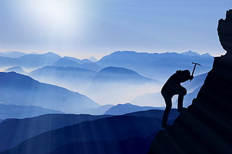 Silhouette of Mountaineer Climbing Mountain Peak at Sunrise