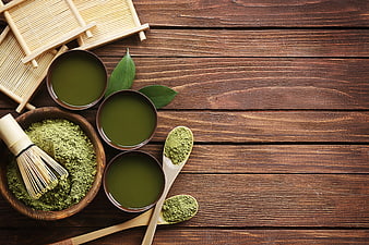 Matcha Tea Preparation with Bamboo Whisk on Wooden Table