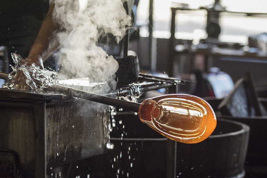 Glassblower Shaping Molten Glass with Water and Steam