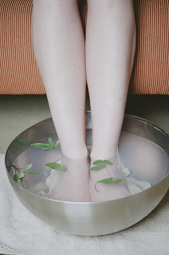 Relaxing Herbal Foot Bath With Fresh Sage Leaves In Metal Bowl