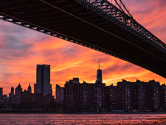 Dramatic Sunset Skyline Under Bridge Silhouette