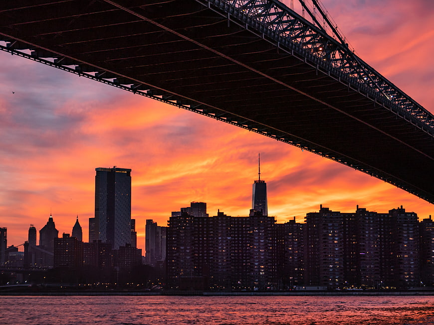 Dramatic Sunset Skyline Under Bridge Silhouette