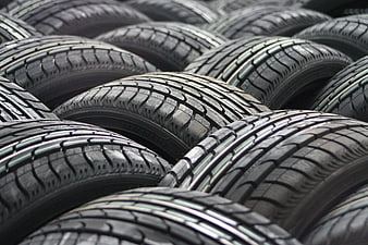 Stack of new car tires with detailed tread pattern