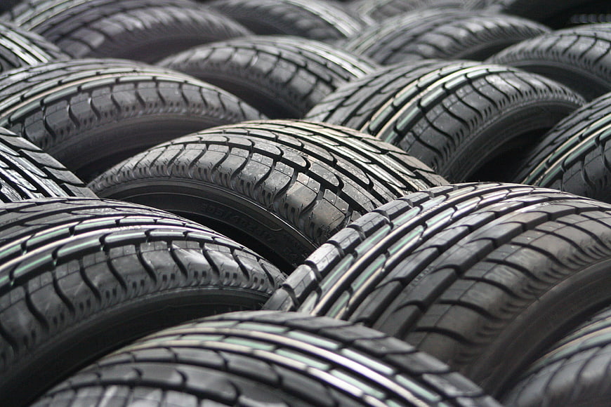 Stack of new car tires with detailed tread pattern