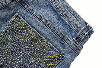 Close-up of blue denim jeans pocket with yellow stitching