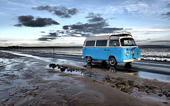 Vintage Blue and White VW Camper Van on Coastal Road