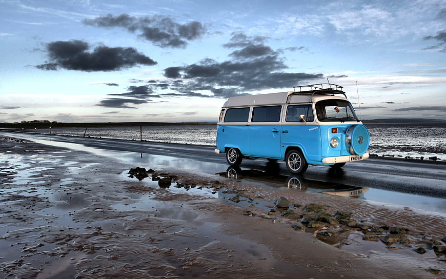 Vintage Blue and White VW Camper Van on Coastal Road