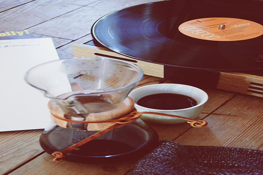 Vinyl Record Player and Pour Over Coffee on Wooden Table