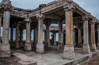 Ancient stone pillars of a ruined pavilion in India