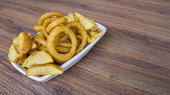 Assorted fried potato snacks on white plate