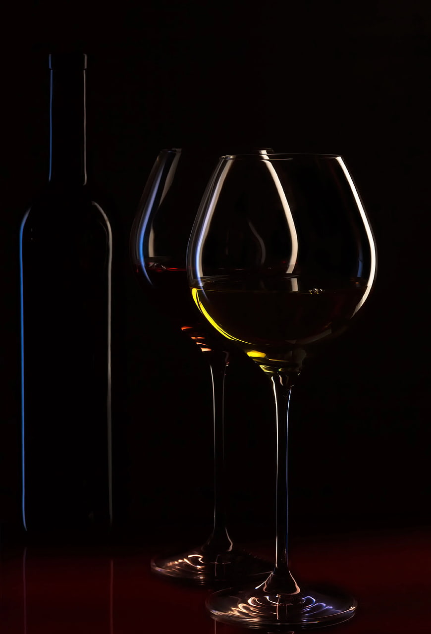 Silhouette of Wine Glasses and Bottle on Dark Background