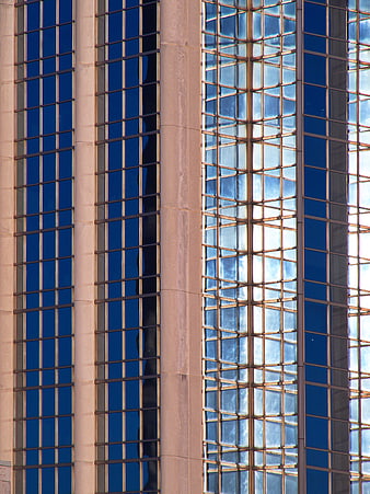 Modern Glass Building Facade with Blue Reflections