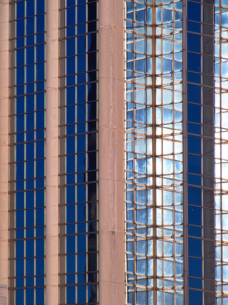 Modern Glass Building Facade with Blue Reflections