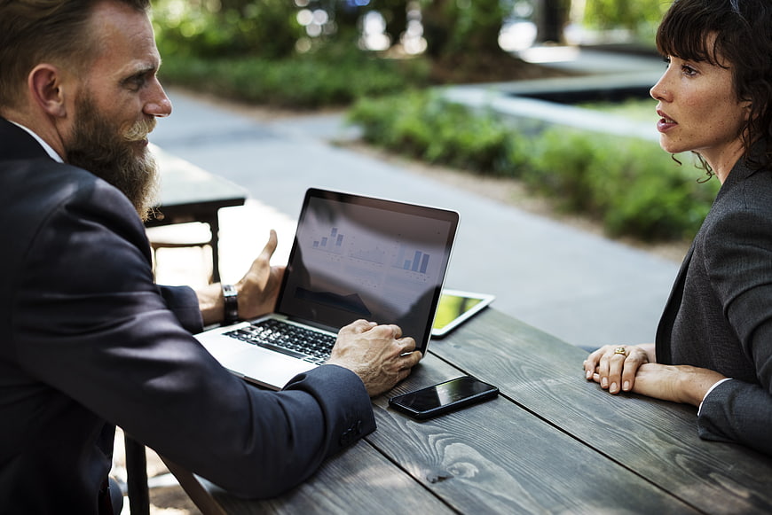 Business meeting outdoors with laptop and tablet