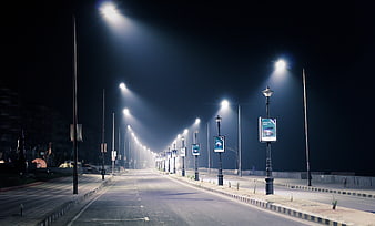Empty City Street At Night With Illuminated Streetlights