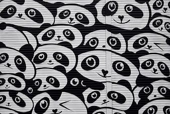 Black and white panda street art mural on urban roller shutter