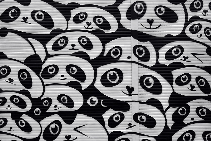 Black and white panda street art mural on urban roller shutter