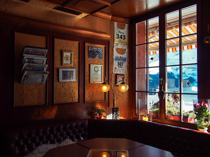 Cozy Alpine Cafe Interior With Mountain View Through Window