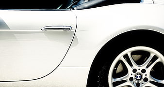 Close-up of White BMW Car Door and Alloy Wheel