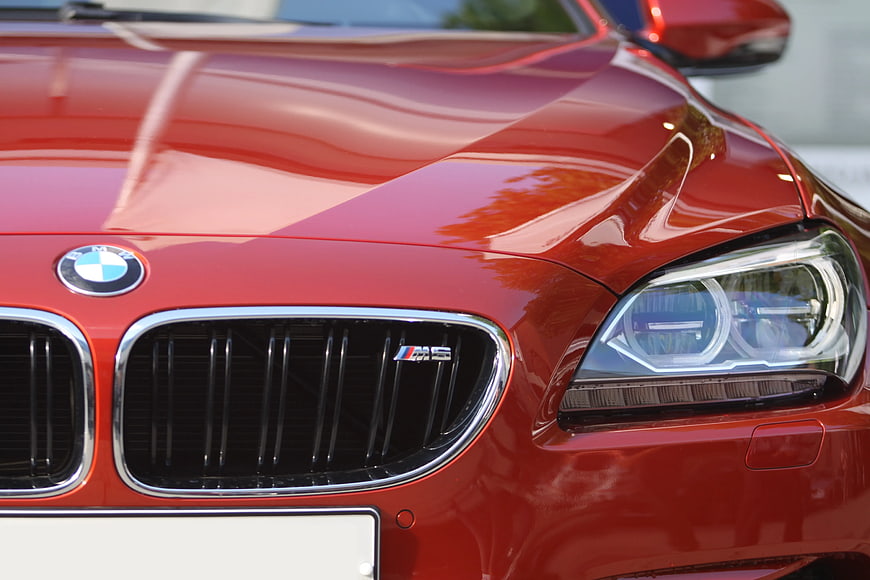 Close-up of Red BMW M5 Front Grille and Headlight