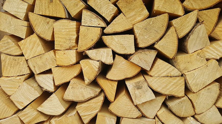 Stacked Firewood Logs Close-Up Texture Background