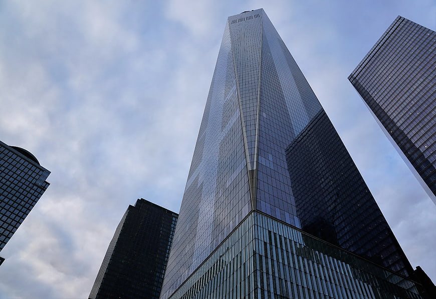Low Angle View of Modern Glass Skyscraper Against Cloudy Sky