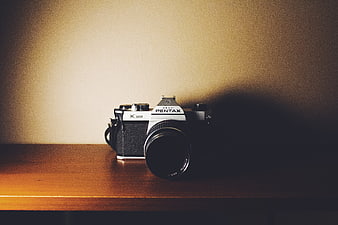 Vintage Pentax K1000 Camera on Wooden Shelf
