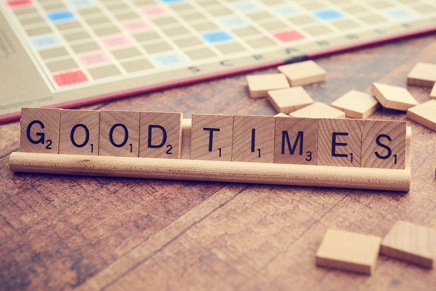 Scrabble Tiles Spelling Good Times on Wooden Rack