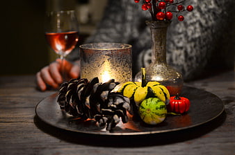 Autumn table setting with wine, candle, and harvest decorations