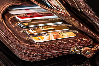 Close-up of worn brown leather wallet with credit cards