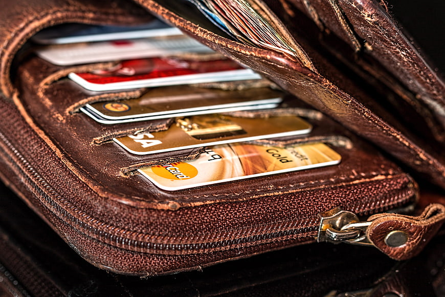 Close-up of worn brown leather wallet with credit cards