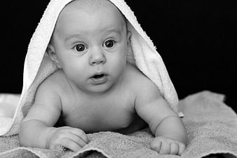 Black and White Portrait of Curious Baby on Towel