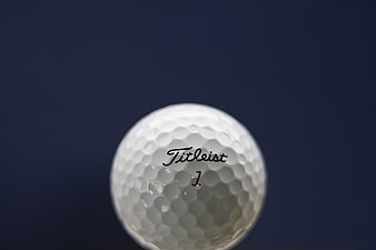 Close-up of Titleist Golf Ball on Blue Background