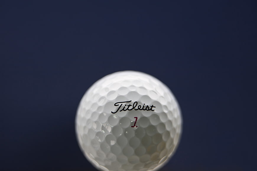 Close-up of Titleist Golf Ball on Blue Background