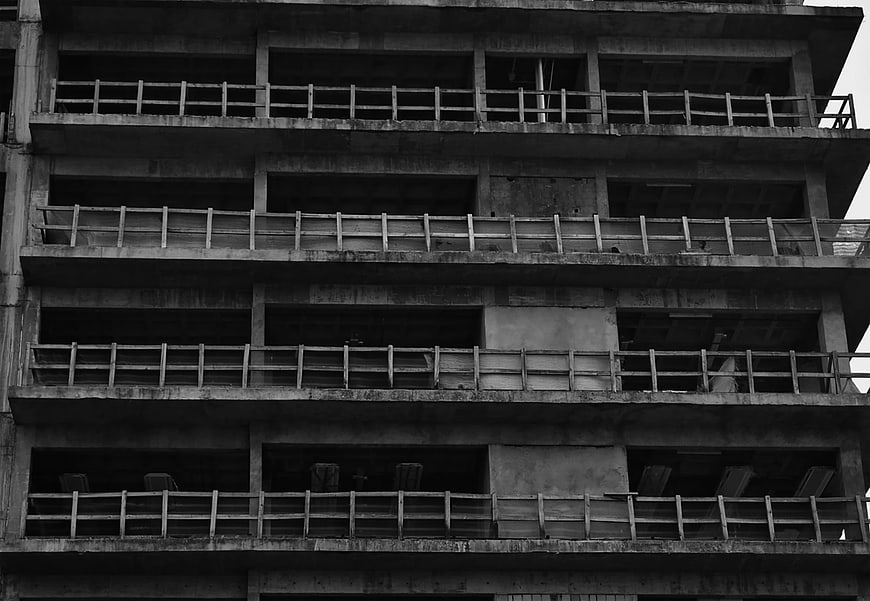Black and white photo of unfinished concrete building facade
