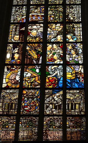 Historical Stained Glass Window with Religious Figures and Heraldry