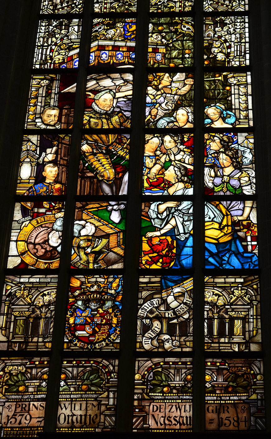 Historical Stained Glass Window with Religious Figures and Heraldry