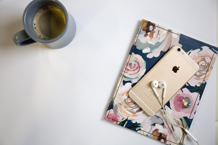 Flat Lay of Coffee Mug, Smartphone, and Floral Notebook