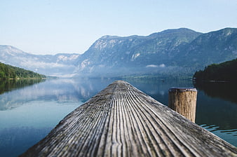 Wooden Dock Leading to Misty Mountain Lake Landscape