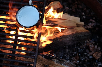 Enamel Mug Heating Over Campfire Grill