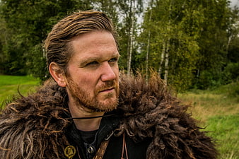 Portrait of a man in Viking fur costume in a forest